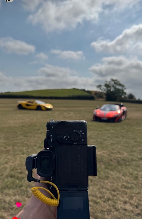 Reece shooting McLarens on location with a camera in hand